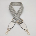 Macro view of woven grey geometric strap with gold metal buckles and white leather ends - Type 3 Gray With White Leather