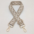 Detail of adjustable geometric jacquard strap with gold-tone hardware buckles and hooks - Beige Base Khaki