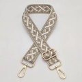 Detail view of ethnic geometric jacquard bag strap with gold metal hooks and adjuster - Beige Camel