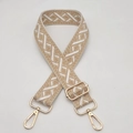 Detail of widened jacquard guitar strap with geometric pattern and gold swivel hooks - Beige Lotus Root
