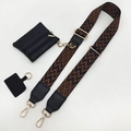 Detail view of ethnic style jacquard strap with gold hardware and leather coin pouch - Black Brown