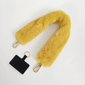Vibrant yellow plush faux fur phone strap with golden lobster clasps and a black patch - Yellow