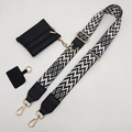 Detail of adjustable geometric strap with a black mini zipper pouch and gold hardware - Black and White