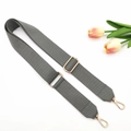 Detail of adjustable gray woven canvas bag strap with gold metal swivel lobster hooks - Gray