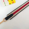 Detail of woven striped bag strap with black leather ends and gold metal chain links - Black Stripe