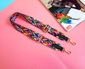 Close-up of colorful ethnic pattern woven bag strap with golden metal lobster clasps - Black (Black Edging)