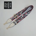 Close-up of ethnic geometric pattern strap with golden metal clasps for crossbody bags - Tiger Pattern White