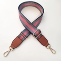 Close-up of adjustable nylon strap with red, blue, and white chevron pattern and gold clips - Black Gold Line + Brown