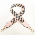 Detail of adjustable woven wide purse strap with pink and grey arrow pattern and gold hooks - Pink