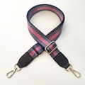 Close-up of a striped nylon bag strap with high-density weave and gold metal hooks - Blue Silver Line + Black