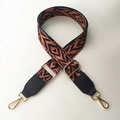 Detail of adjustable geometric strap with orange bohemian pattern and gold lobster clasp - Brown Strap + Black