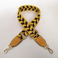 Close-up of adjustable woven shoulder strap with yellow and blue chevron pattern and gold hooks - Bright Yellow Black Grid
