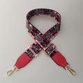 Detail of adjustable woven bag strap with geometric patterns and golden metal hardware - Charming Color + Red
