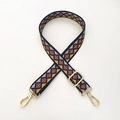 Close-up of geometric ethnic pattern woven strap with gold metal buckles for bags - Argyle