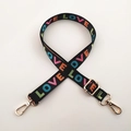 Detail of black woven shoulder strap with colorful LOVE text and gold metal buckles - Colorful Love