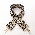 Detail of adjustable wide bag strap with black and white leopard pattern and gold hardware - Beige Leopard