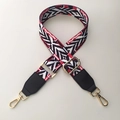 Close-up of ethnic geometric pattern woven strap with gold metal buckles and leather ends - Rainbow + Black