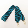 Dettaglio tracolla in nylon zebrato blu e nero con ganci in metallo dorato - Verde petrolio