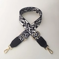 Detail of colorful ethnic geometric woven bag strap with golden metal lobster hooks - White Tiger + Black