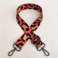 Detailed view of high-density nylon leopard print strap with gunmetal swivel hooks - Orange With Gunmetal Buckle