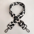 Detail of adjustable nylon leopard strap with dark grey metal hooks and thick webbing - Grey Gunmetal Buckle