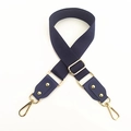 Close-up of adjustable wide woven cotton bag strap in navy blue with gold metal hardware - Blue