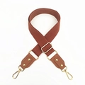 Detail of adjustable brown woven cotton strap with gold metal buckles and leather ends - Brown