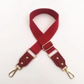 Detail of red canvas shoulder strap with gold lobster clasps and leather reinforcement - Burgundy