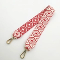 Close-up of ethnic geometric pattern woven bag strap with golden lobster metal clasps - Red Short