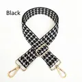 Close-up of black and white houndstooth bag strap with adjustable gold lobster clasps - Black