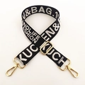 Detail of black and white woven bag strap with golden metal hooks and adjustable buckle - 1980 Letters