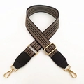 Detail of adjustable striped canvas bag strap with gold metal hooks and leather accents - Dark Gray