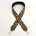 Detailed close-up of ethnic floral embroidery on a black wide guitar style bag strap - Style 5