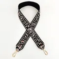 Close-up of wide embroidered shoulder strap with floral patterns and golden swivel hooks - Style 10