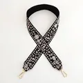 Detail of embroidered floral bag strap in black with light gold metal swivel hooks - Style 11