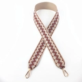 Close-up of geometric jacquard bag strap with gold lobster clasps and brown zigzag patterns - Pink Brown