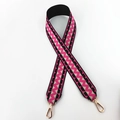 Close-up of wide woven bag strap with pink and black geometric patterns and gold clips - Black Rose Pink