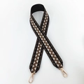 Detail of woven bag strap with geometric wave pattern and gold metal swivel hooks - Black with Light Coffee