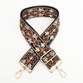 Close-up of vintage floral jacquard bag strap with gold metal buckles and embroidery - Black Base Brown