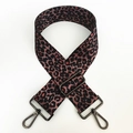 Detail of adjustable leopard print bag strap with gunmetal lobster clasps and red accents - Coffee Leopard (Gunmetal Buckle)