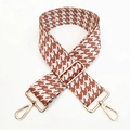 Detail of adjustable wide shoulder strap featuring brown houndstooth jacquard and gold metal hooks - White & Brown