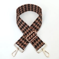 Close-up of thick jacquard woven houndstooth strap with golden metal lobster clasps - Black Brown