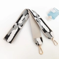 Close-up of jacquard woven strap in black, white, gray pattern with golden lobster clasp - Black White Grey