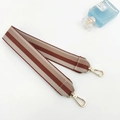 Detail view of striped canvas replacement shoulder strap with gold metal lobster clasps - Brown Short