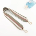Detail of wide woven shoulder strap with green and pink stripes and gold lobster clasps - Bean Green Long Style
