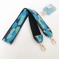 Detail of blue and green geometric python pattern woven shoulder strap with gold lobster clasps - Black Frame Light Blue Lens