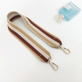 Detail of multi-color striped canvas bag strap with gold metal hooks on white background - Yellow Long Style