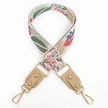 Detail of bohemian jacquard flower strap with gold metal hooks and beige leather ends - Khaki
