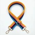 Close-up of colorful striped wide strap with gold metal swiveling hooks and adjuster - Rainbow Yellow Blue