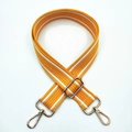 Detail of wide orange woven bag strap with white stripes and gold metal lobster clips - Yellow White Stripe